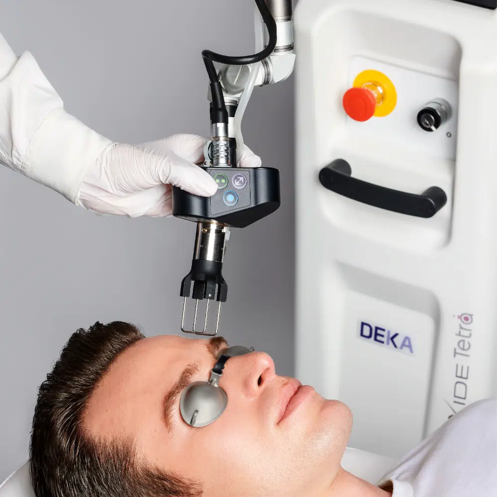 deka A man getting his face cleaned by an ophthalmologist.